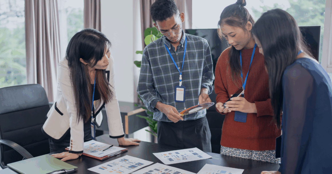 Engineers reviewing performance data on a chart during a team discussion.